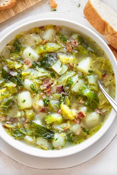 a white bowl filled with soup next to bread