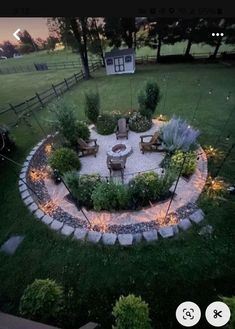 an outdoor fire pit in the middle of a yard