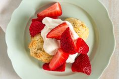 some strawberries and cream are on a plate