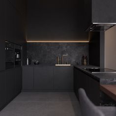 a modern kitchen with black cabinets and counter tops