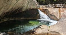 there is a waterfall in the middle of some rocks