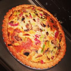 an uncooked pizza sitting on top of a stove