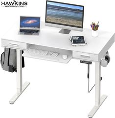 a computer desk with a laptop and monitor on it