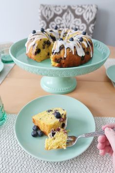 a blueberry bunt cake on a plate with a bite taken out of it