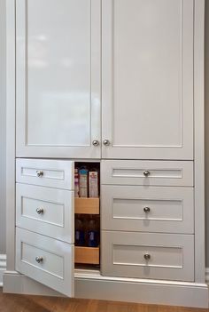 an open cabinet with drawers in a room