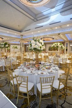 a banquet hall with tables and chairs set up for an event