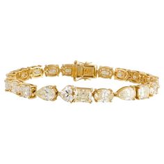 The Following Item we are offering is this Beautiful Rare Important 18KT Yellow Gold Large Glittering Fancy Cut Yellow Diamond Tennis Bracelet. Bracelet is comprised of over 23CTS Magnificent Rare Gorgeous Fancy Oval, Heart, Pear, & Emerald Cut Glittering Diamonds!!! The Diamonds are of Beautiful Fine Quality. This Magnificent Bracelet is a Rare Sample Piece From a Private Manufacturer that sold to select Five Star Hotel and Fine Jewelry Stores. Original Retail $250,000 and Comes with a Certificate from the IGI. Bracelet Tennis, Modern Bracelets, Fancy Yellow Diamond, Diamond Tennis Bracelet, Five Star Hotel, Fancy Diamonds, Star Hotel, Tennis Bracelet Diamond, Diamond Drops