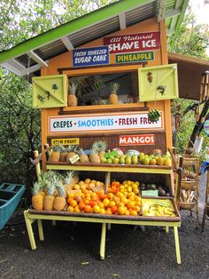 an outdoor fruit stand with fresh fruits and vegetables