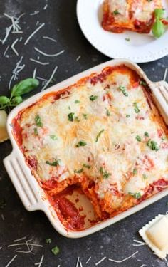 lasagna casserole with cheese and herbs on the side, ready to be eaten