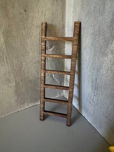 a wooden ladder leaning against a wall