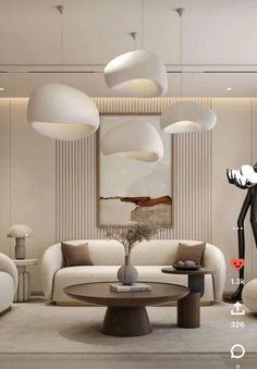 a living room filled with white furniture and lots of lamps hanging from the ceiling above