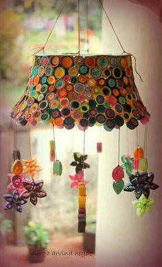 a chandelier made out of buttons and other items hanging from it's sides