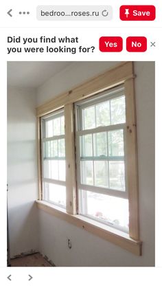 an empty room with two windows in it