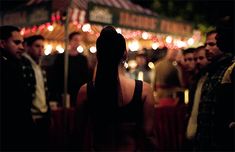 the back of a woman's head as she stands in front of a group of people