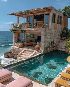 an outdoor swimming pool next to the ocean