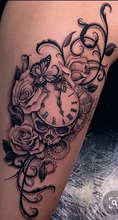 a woman's thigh with a clock and roses tattoo on it