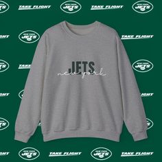 Show your support for the New York Jets with this classic Gildan Crewneck Sweatshirt. Perfect for game days, tailgating, or casual wear, this crewneck is designed for comfort and durability. Made from ethically sourced, 100% US-grown cotton, it offers a relaxed fit and a crew neckline for a timeless look that suits every occasion. Whether you're at the stadium or watching from home, this sweatshirt lets you represent your team in style! Cheer on the New York Jets with this stylish and comfortable Gildan Crewneck Sweatshirt. Whether you're at the stadium or watching from home, this sweatshirt is the perfect way to show your team pride. Order yours today! Perfect for: * New York Jets Fans * NFL Enthusiasts * Young Adults (18-34) * Football Lovers * Casual Sportswear Collectors Why You'll Lov New York Jets Football, Jets Football, Football Lovers, Casual Sportswear, Team Apparel, New York Jets, Nfl Teams, Crew Neckline, Crewneck Sweatshirt