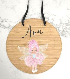 a personalized wooden sign with a little fairy girl in pink on the front and bottom