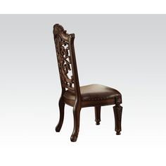 an ornate wooden chair with leather upholstered seat