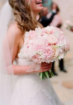 a woman in a wedding dress holding a bouquet