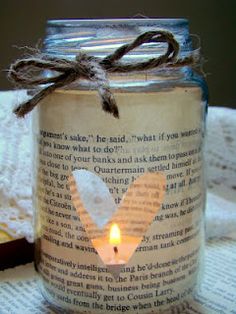 a candle that is sitting on top of a book page with a string around it