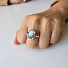 AAA Rainbow Moonstone ring, Real Sterling Silver ring, cocktail ring, alternative engagement ring, avant garde, birthstone ring, Rainbow Moonstone jewellery Description: Be assured that the product you order is MADE JUST FOR YOU and is not a mass produced item. The gemstone is a OVAL shaped AAA RAINBOW MOONSTONE GEMSTONE SIZE-16*12 mm. You have an option to choose a gem for yourself from a set of the stones. Please ask. The rest of the ring is made from 925 STERLING SILVER. And it DOESN'T HAVE A Mystical Iridescent Sterling Silver Rings, Iridescent Oval Sterling Silver Rings, Iridescent Gemstone Promise Ring, Iridescent Moonstone Gemstone Ring, Handmade Iridescent Sterling Silver Ring, Handmade Open Moonstone Ring In Fine Jewelry Style, Handmade Moonstone Open Ring Fine Jewelry, Iridescent Moonstone Ring In Sterling Silver, Handmade Open Moonstone Ring Fine Jewelry