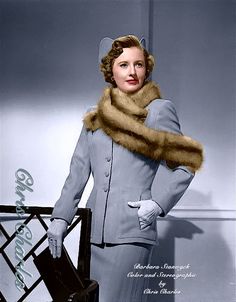 an old photo of a woman in a suit and fur stoler