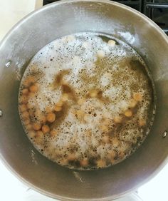 a pan filled with food sitting on top of a stove next to a burner