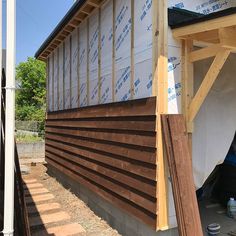 the side of a house being built with siding on it's roof and walls