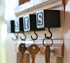 several keys are hanging on the wall near a window