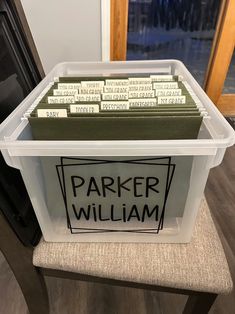 a plastic container with labels on it sitting on a chair