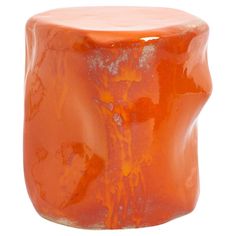 an orange colored stool made out of plastic