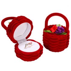 a red ring box with flowers in it on a white background and the lid opened