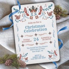 a christmas celebration card with pine cones and blue ribbon on the bottom, surrounded by other decorations