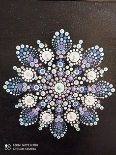 a painting of a snowflake made out of buttons