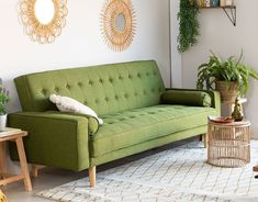 a green couch sitting on top of a white rug