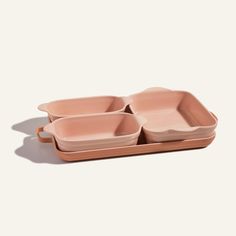 three pink dishes sitting on top of each other