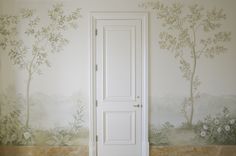 an open door in front of a wall mural