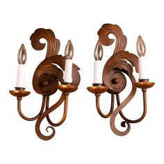 two wooden sconces with candles attached to them