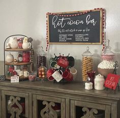 a buffet table with lots of food on top of it and a sign that says hot cocoa bar