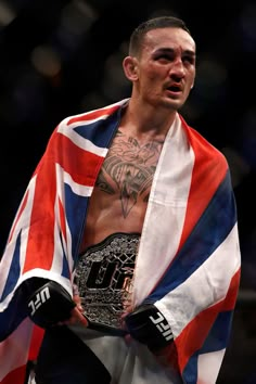 a man with a flag draped around his shoulders