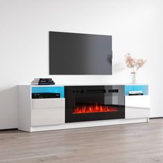 an entertainment center with a television and fire in the fireplace