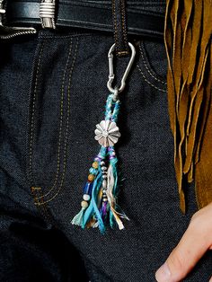 a person wearing a belt with a tassel attached to the back of their waist