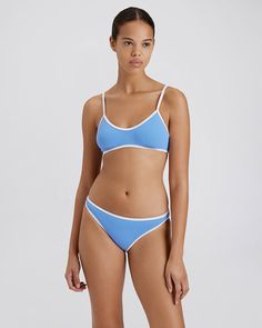 Updated with a more moderate fit and offered in our new lightweight ribbed fabrication, The Rachel Ribbed Bikini Bottom is the perfect low-rise bottom. Wear it at or above the hip for a leg-lengthening effect. Crafted from recycled materials and designed to provide UPF 50+ protection. Casual Ribbed Swimwear For Pool, Casual Ribbed Swimwear For Swimming, Poolside Ribbed Triangle Top Swimwear, Blue Ribbed Bottoms For Summer, Blue Swimwear With Seamless Construction For Beach, The Rachel, Marina Blue, Solid & Striped, Blue Solid