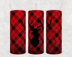 three red and black plaid candles with deer heads on them