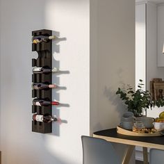 a wall mounted wine rack in the corner of a room with a table and chairs