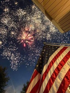 an american flag and fireworks in the sky