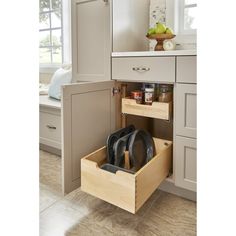 an open drawer in the middle of a kitchen