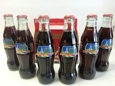 six bottles of soda sitting next to each other