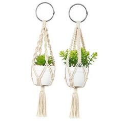 two hanging planters with plants in them and one holding a potted plant on the other